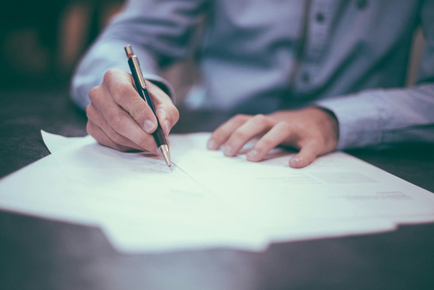 An adviser working through documentation to build a record of processing